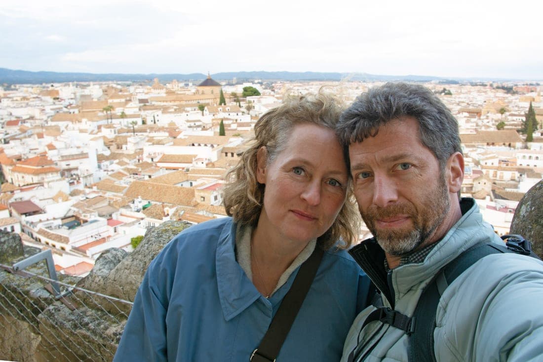 Brandon and Anne on a rooftop overlooking a Cordoba Spain with hills in the distance
